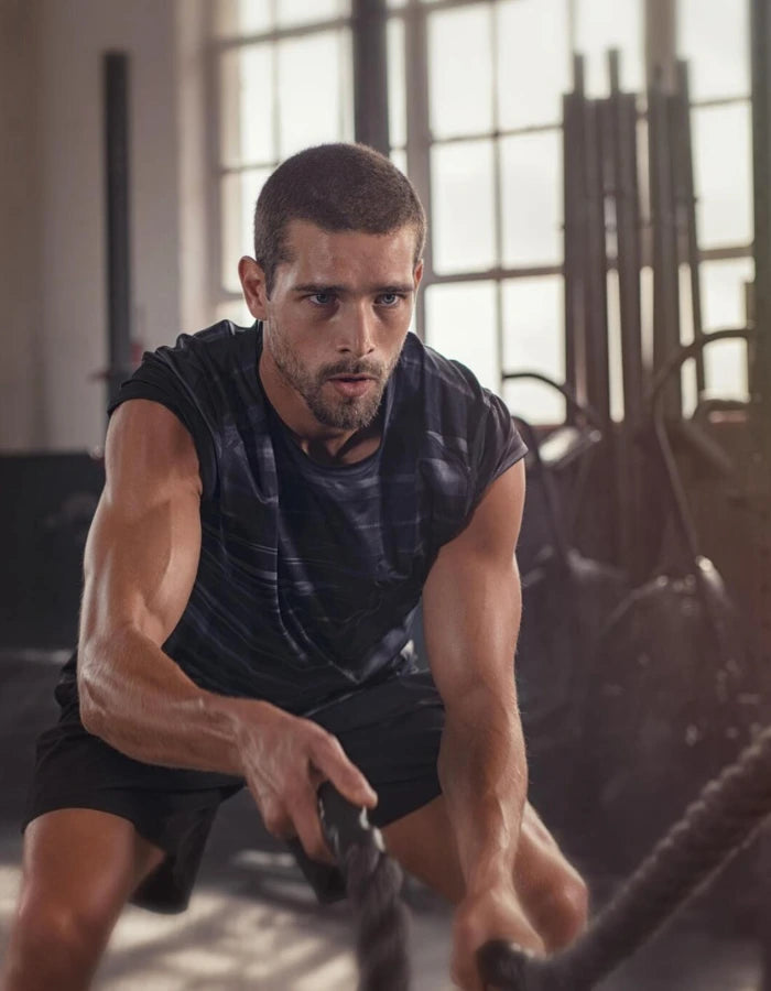 Use StudPre Man exercising with resistance ropes in a gym setting